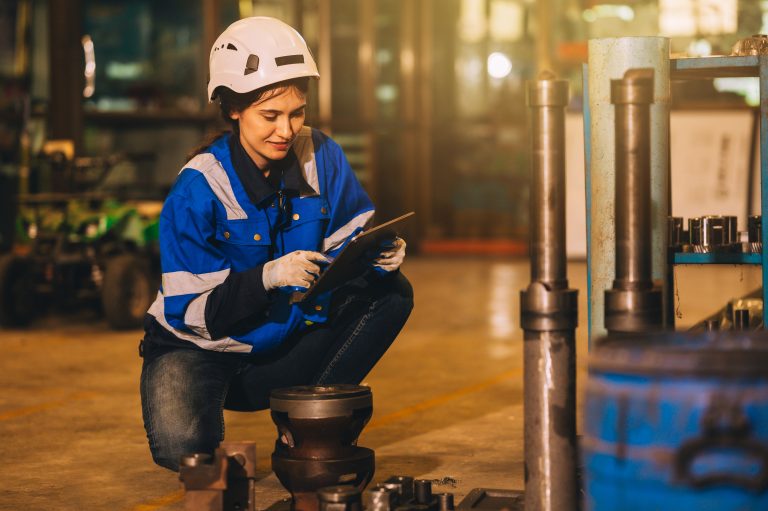 woman checking safety of a machine and laithe