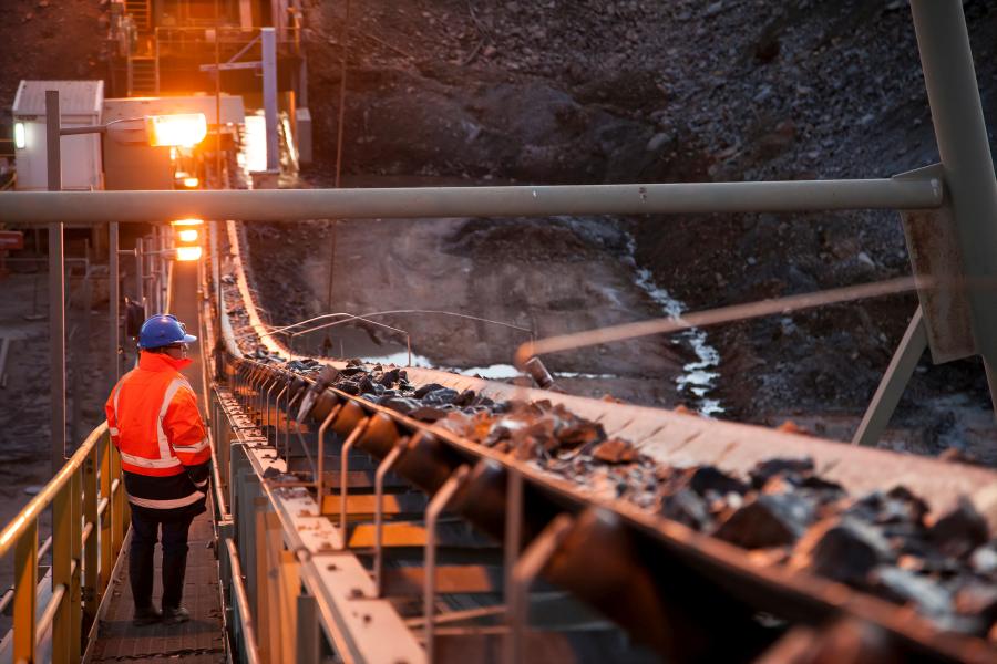 Miner watches coal come out of shoot.
