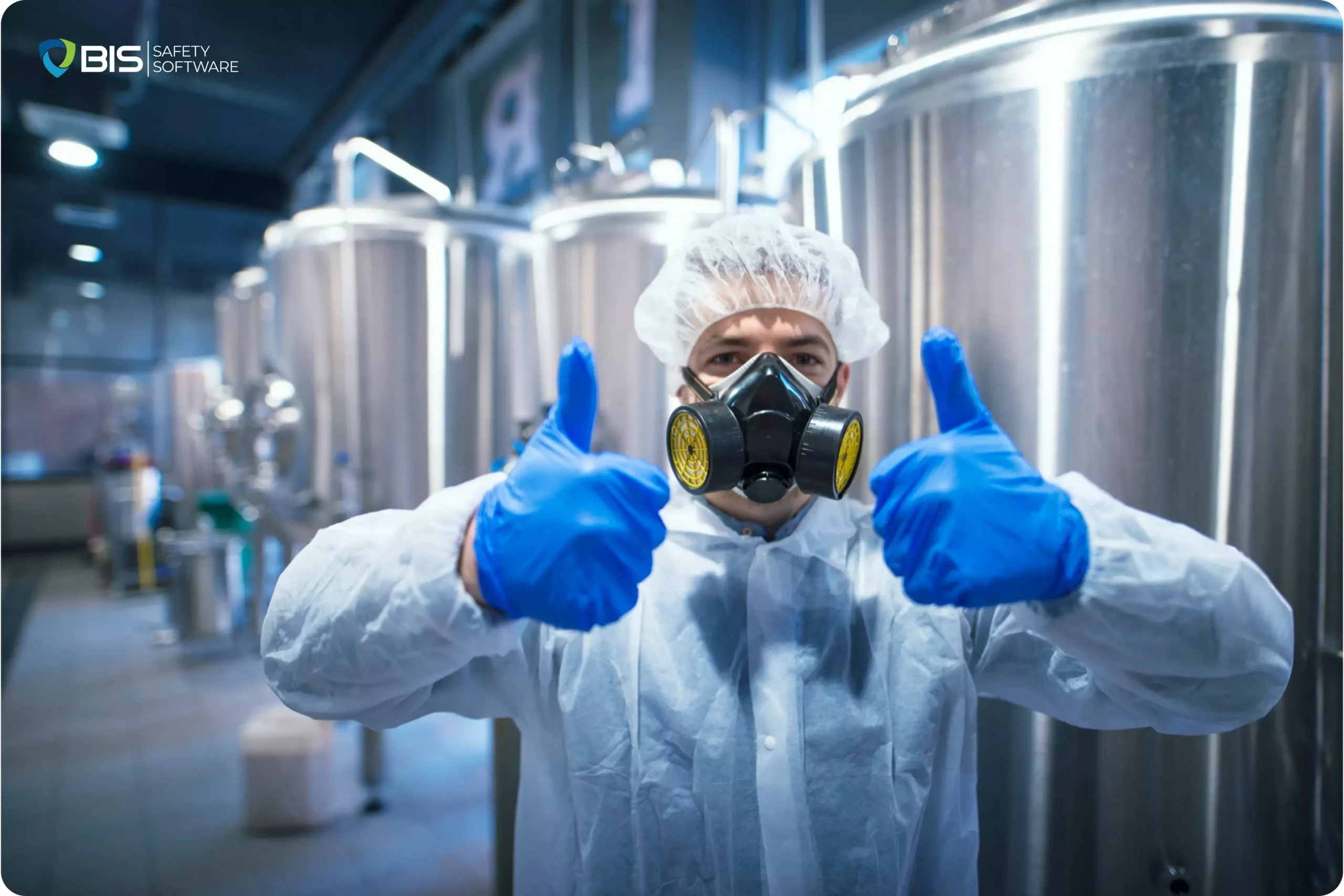 A man Wearing a hazmat suit in a laboratory, showing thumbs-up