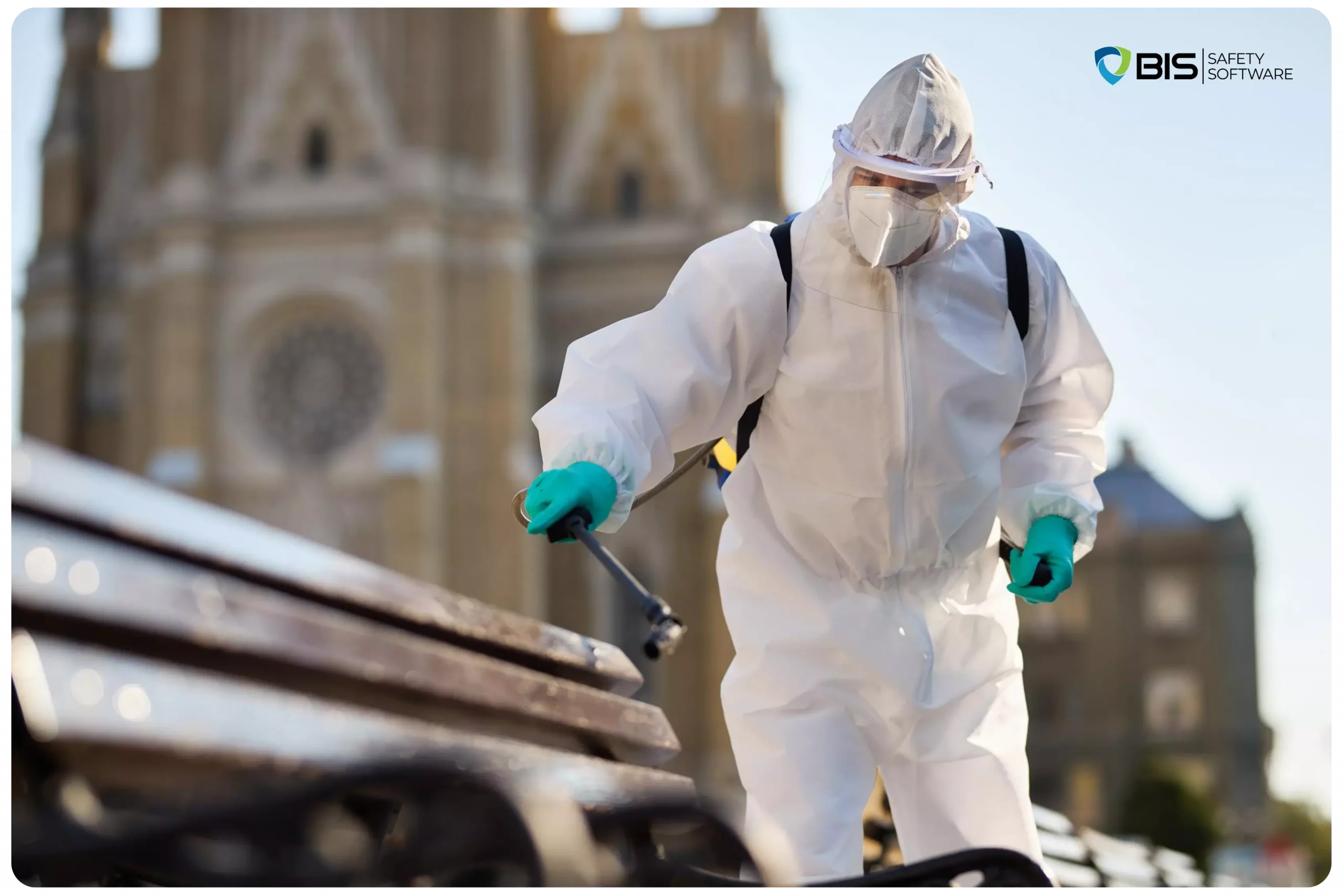 A man wearing a hazmat suit, disinfecting public benches.