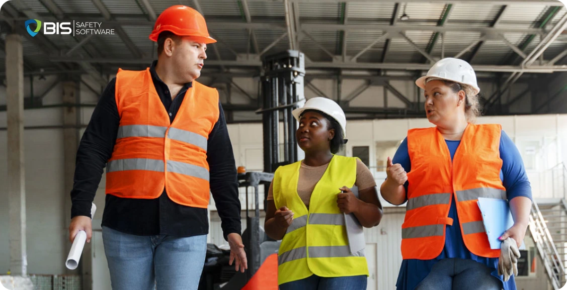Employees at a jobsite, discussing workplace safety
