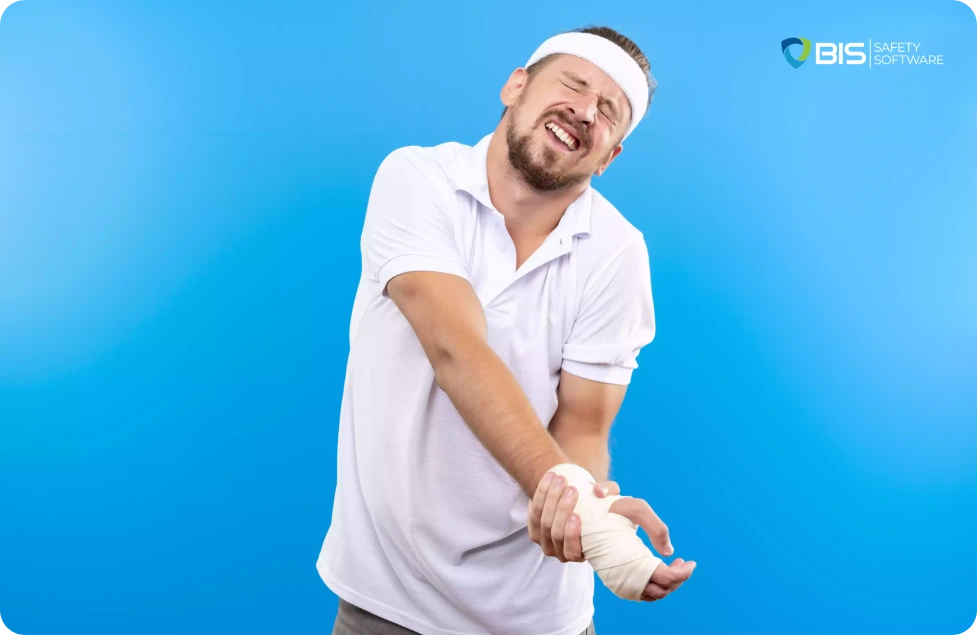 Man in pain, holding on to his injured hand