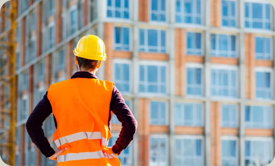 A Construction Worker standing in front of a site.